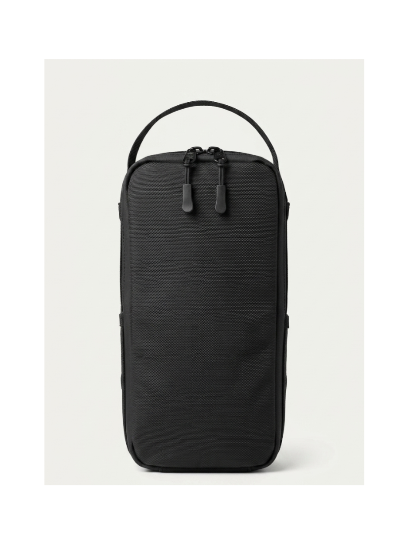 A black textured nylon travel pouch with a top carry handle and dual zipper pulls, shown against a light gray background.