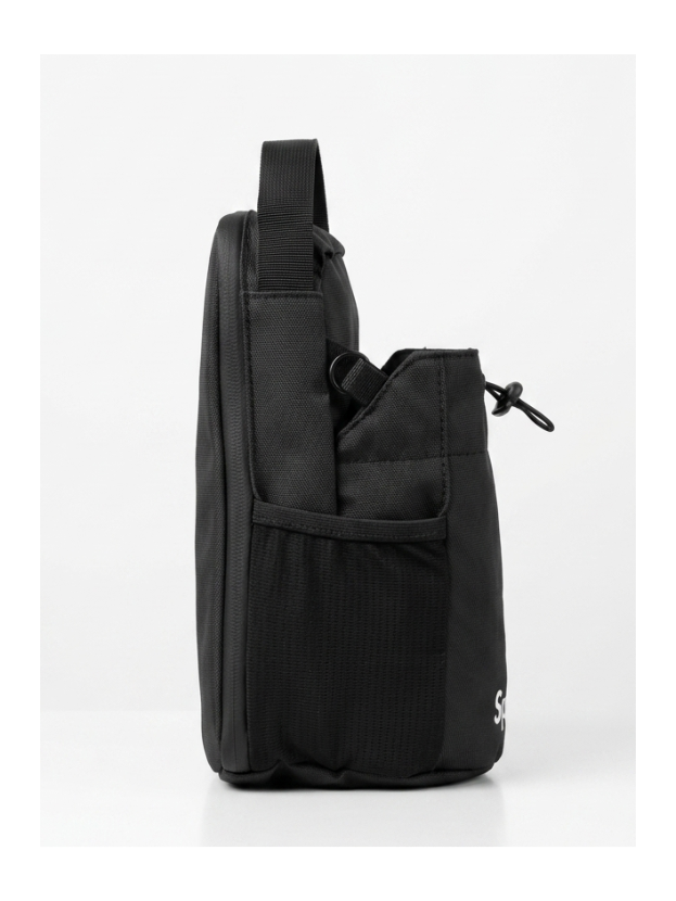A black nylon shoulder bag shown from the side profile, resting on a white platform against a white studio background.